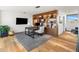 Stylish home office with custom built-in shelving, modern desk, and gray rug on hardwood floors at 10283 E Running Deer Trl, Scottsdale, AZ 85262