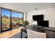 Bright home office with mountain views, a large desk, and access to a patio at 10283 E Running Deer Trl, Scottsdale, AZ 85262