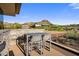 This outdoor deck area features a bar-height table and chairs with mountain views at 10283 E Running Deer Trl, Scottsdale, AZ 85262