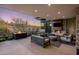 Relaxing outdoor area with a modern fireplace, comfortable seating, and scenic views of the surrounding desert landscape at 10283 E Running Deer Trl, Scottsdale, AZ 85262