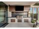 Well-equipped outdoor kitchen featuring a built-in grill, countertop space, and storage cabinets for outdoor cooking at 10283 E Running Deer Trl, Scottsdale, AZ 85262