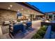 Expansive outdoor living space with a kitchen, fireplace, and multiple seating, perfect for entertainment at 10283 E Running Deer Trl, Scottsdale, AZ 85262