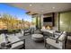Inviting outdoor living area with a fireplace, comfortable seating, and scenic views at 10283 E Running Deer Trl, Scottsdale, AZ 85262