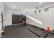This workout room features ample space, storage cabinets, and natural light from a window at 10283 E Running Deer Trl, Scottsdale, AZ 85262