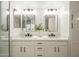 Stylish bathroom featuring dual sinks with modern fixtures, quartz countertops, and sleek mirrors at 12222 N Paradise Vlg S Pkwy # 237, Phoenix, AZ 85032