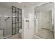 Modern bathroom features a glass shower enclosure, white tile and a large mirror at 12222 N Paradise Vlg S Pkwy # 237, Phoenix, AZ 85032