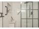 Modern bathroom featuring a glass shower enclosure, marble tile, and built-in shelf for toiletries at 12222 N Paradise Vlg S Pkwy # 237, Phoenix, AZ 85032