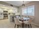 Charming dining area adjacent to the kitchen with a modern light fixture and window view at 12222 N Paradise Vlg S Pkwy # 237, Phoenix, AZ 85032