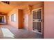 Charming peach-colored exterior walkway featuring security doors, offering secure access to the apartments at 12222 N Paradise Vlg S Pkwy # 237, Phoenix, AZ 85032