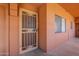 Inviting peach-colored entry featuring a security screen door and window, providing safety and natural light at 12222 N Paradise Vlg S Pkwy # 237, Phoenix, AZ 85032