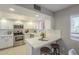 Bright, updated kitchen with stainless steel appliances, white cabinetry and a peninsula with seating at 12222 N Paradise Vlg S Pkwy # 237, Phoenix, AZ 85032