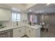 Bright kitchen boasts white cabinets, quartz countertops, stainless appliances, and a dining area at 12222 N Paradise Vlg S Pkwy # 237, Phoenix, AZ 85032