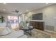 Well-lit living room showing a modern TV, furniture, and sliding doors leading to the patio at 12222 N Paradise Vlg S Pkwy # 237, Phoenix, AZ 85032