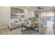 Bright living room with stylish furniture, decor, and a view of the outdoor patio at 12222 N Paradise Vlg S Pkwy # 237, Phoenix, AZ 85032