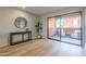 Living room features light wood floors, stylish console table, and sliding doors to a private patio at 12222 N Paradise Vlg S Pkwy # 237, Phoenix, AZ 85032
