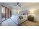 Relaxing main bedroom featuring a ceiling fan, light walls, a king bed, and sliding door to patio at 12222 N Paradise Vlg S Pkwy # 237, Phoenix, AZ 85032
