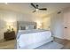 Bright main bedroom featuring a ceiling fan, white walls, a king bed, and two bedside lamps at 12222 N Paradise Vlg S Pkwy # 237, Phoenix, AZ 85032