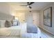 Light-filled main bedroom featuring a king bed, ceiling fan, neutral paint, and two doors at 12222 N Paradise Vlg S Pkwy # 237, Phoenix, AZ 85032