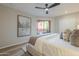 Bright main bedroom featuring a king bed, neutral paint, a ceiling fan, and access to the patio at 12222 N Paradise Vlg S Pkwy # 237, Phoenix, AZ 85032