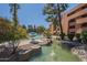 Lush pond surrounded by rock landscaping near seating, offers a tranquil outdoor retreat for relaxation at 12222 N Paradise Vlg S Pkwy # 237, Phoenix, AZ 85032