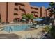 Tranquil community pool with a rock waterfall feature, set against the complex, a relaxing spot at 12222 N Paradise Vlg S Pkwy # 237, Phoenix, AZ 85032