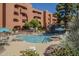 Community pool with a charming waterfall, surrounded by lounge chairs, offers a serene escape at 12222 N Paradise Vlg S Pkwy # 237, Phoenix, AZ 85032