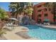 Sparkling pool with a waterfall feature surrounded by lounge chairs and lush landscaping, perfect for relaxation at 12222 N Paradise Vlg S Pkwy # 237, Phoenix, AZ 85032