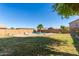 A refreshing backyard pool is surrounded by desert landscaping and mature shade trees at 12571 W Clarendon Ave, Avondale, AZ 85392