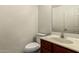 Powder room features a pedestal sink with warm colored vanity and a modern toilet at 12571 W Clarendon Ave, Avondale, AZ 85392