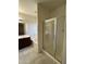 Well-lit bathroom featuring a tiled floor, bathtub, and a sleek glass-enclosed shower at 12571 W Clarendon Ave, Avondale, AZ 85392