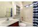 Bathroom featuring a vanity, mirror, shelving, and a shower-tub combo at 12571 W Clarendon Ave, Avondale, AZ 85392