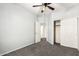 Neutral bedroom with carpet, closet, ceiling fan, and hallway access at 12571 W Clarendon Ave, Avondale, AZ 85392