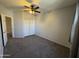 Standard bedroom with carpet, closet, and a ceiling fan at 12571 W Clarendon Ave, Avondale, AZ 85392