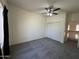 A spacious bedroom with a ceiling fan, closet, and neutral carpeting for a cozy feel at 12571 W Clarendon Ave, Avondale, AZ 85392