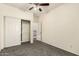 Bright bedroom with gray carpet, closet, and ceiling fan at 12571 W Clarendon Ave, Avondale, AZ 85392