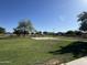 Community park with grass and walking path at 12571 W Clarendon Ave, Avondale, AZ 85392
