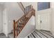 Bright entryway with decorative floors, wood staircase, and large windows at 12571 W Clarendon Ave, Avondale, AZ 85392