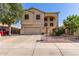 Two-story home with a two-car garage, neutral colors, and low-maintenance desert landscaping at 12571 W Clarendon Ave, Avondale, AZ 85392