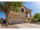 Two-story home with a two-car garage, neutral colors, and low-maintenance desert landscaping at 12571 W Clarendon Ave, Avondale, AZ 85392