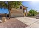 Two-story home with a two-car garage, neutral colors, and low-maintenance desert landscaping at 12571 W Clarendon Ave, Avondale, AZ 85392