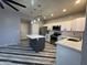 Modern kitchen featuring stainless steel appliances, a large island, white subway tile backsplash, and ample counter space at 12571 W Clarendon Ave, Avondale, AZ 85392