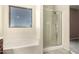 The main bathroom features a soaking tub and separate glass enclosed shower at 12571 W Clarendon Ave, Avondale, AZ 85392