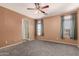 Spacious main bedroom offers plush carpeting, ample natural light, ceiling fan and ensuite bath access at 12571 W Clarendon Ave, Avondale, AZ 85392