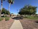 Community park with walking path, playground, and picnic pavilion surrounded by manicured green space at 12571 W Clarendon Ave, Avondale, AZ 85392