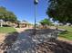 Community playground with swingset and pavilion on a bright sunny day, perfect for families at 12571 W Clarendon Ave, Avondale, AZ 85392