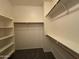 Walk-in closet with carpet flooring and white shelving at 12571 W Clarendon Ave, Avondale, AZ 85392