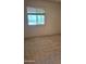Bedroom featuring a window, plush carpeting, and neutral walls at 1336 E Mountain View Rd # 209, Phoenix, AZ 85020