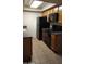 Well-lit kitchen featuring black appliances, tile flooring, and plenty of cabinet space at 1336 E Mountain View Rd # 209, Phoenix, AZ 85020