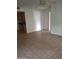 Open-concept living room featuring tile flooring and view into kitchen at 1336 E Mountain View Rd # 209, Phoenix, AZ 85020