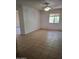 Spacious living room featuring a ceiling fan, tile flooring, and natural light at 1336 E Mountain View Rd # 209, Phoenix, AZ 85020